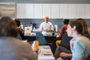 Photo of Chef Romeo Garcia of Romeo Chocolates, giving an artisanal chocolates class in the kitchen and event area of Ironfire Workspaces
